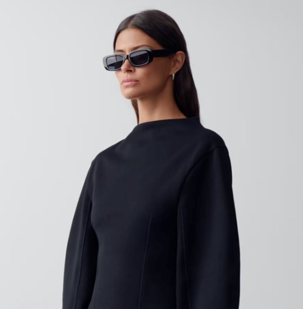 Structured black outerwear in a studio product launch shot